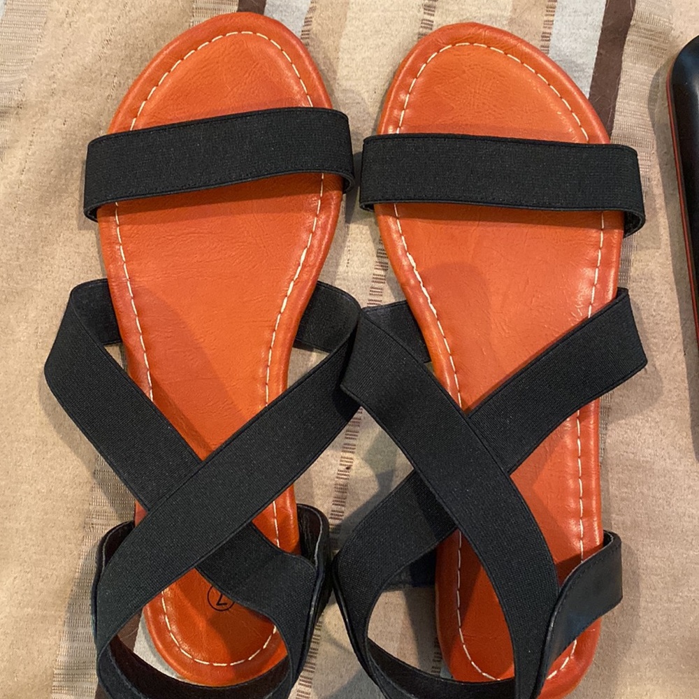 Black strap sandals with tan footbed. Size 7